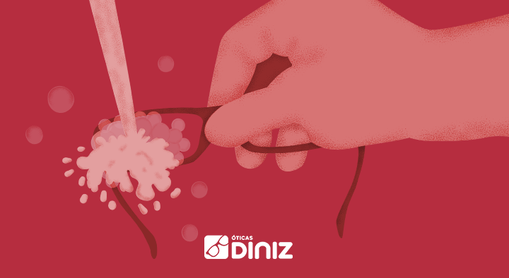 Ilustração em vermelho de uma mão segurando os óculos, enquanto cai água nas lentes para evitar o coronavírus